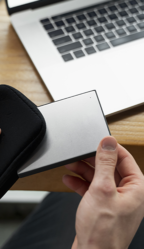 Hand taking out a hard drive