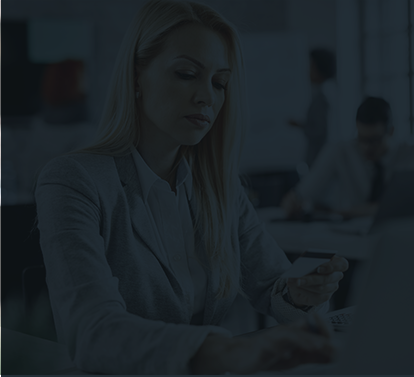 Darkened image of a woman working on her computer